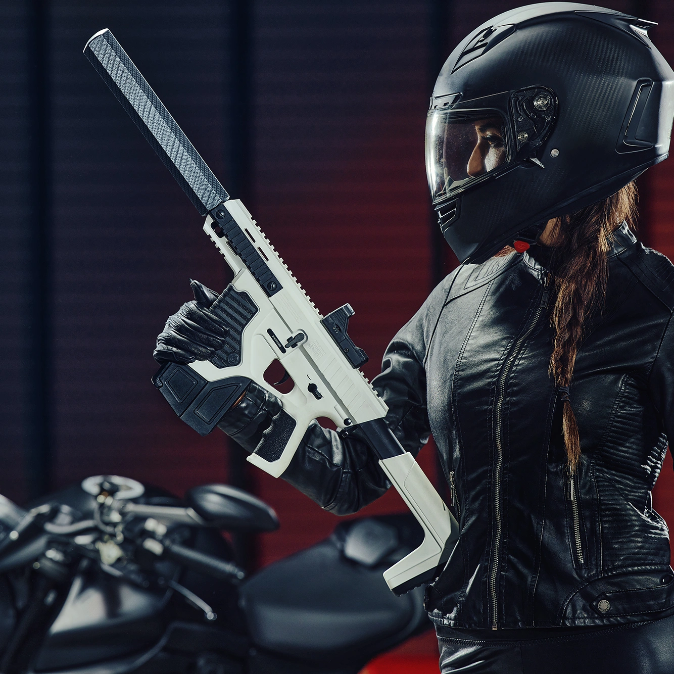 Crosman Full Auto ST-1 (BB) CFAST1X Indoor Lifestyle Woman Holding BB Gun near Motorcycle