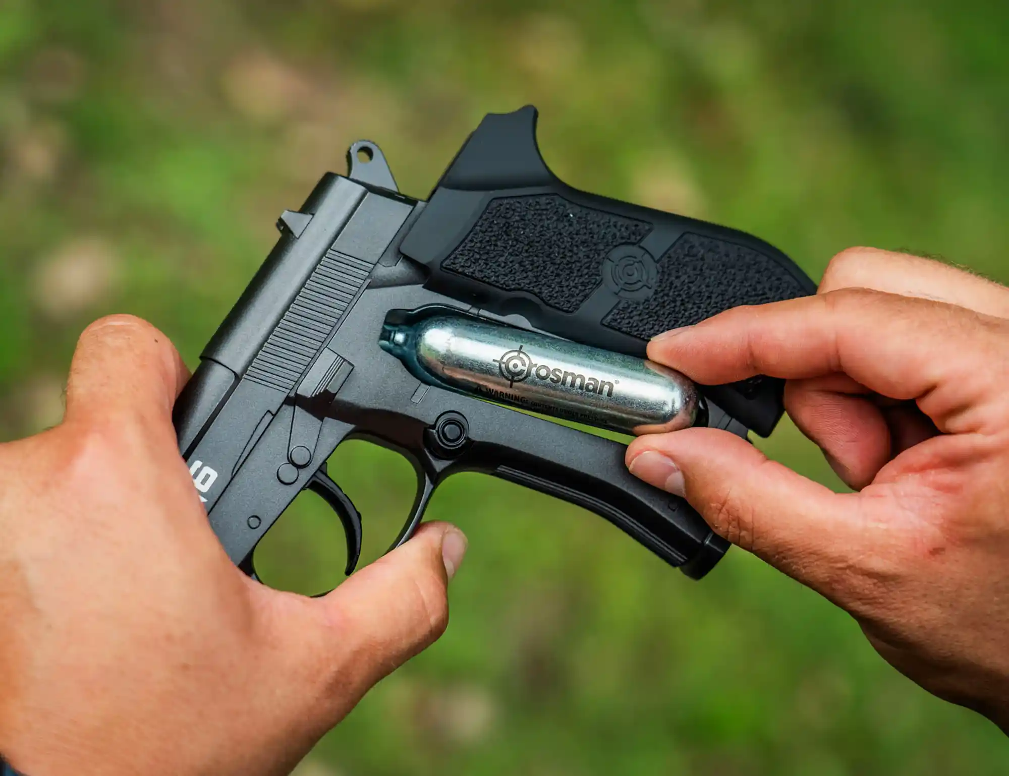 Crosman PFM16 (Black) C02 Pistol PFM16 Outdoor Lifestyle Being Loaded with C02 Powerlet