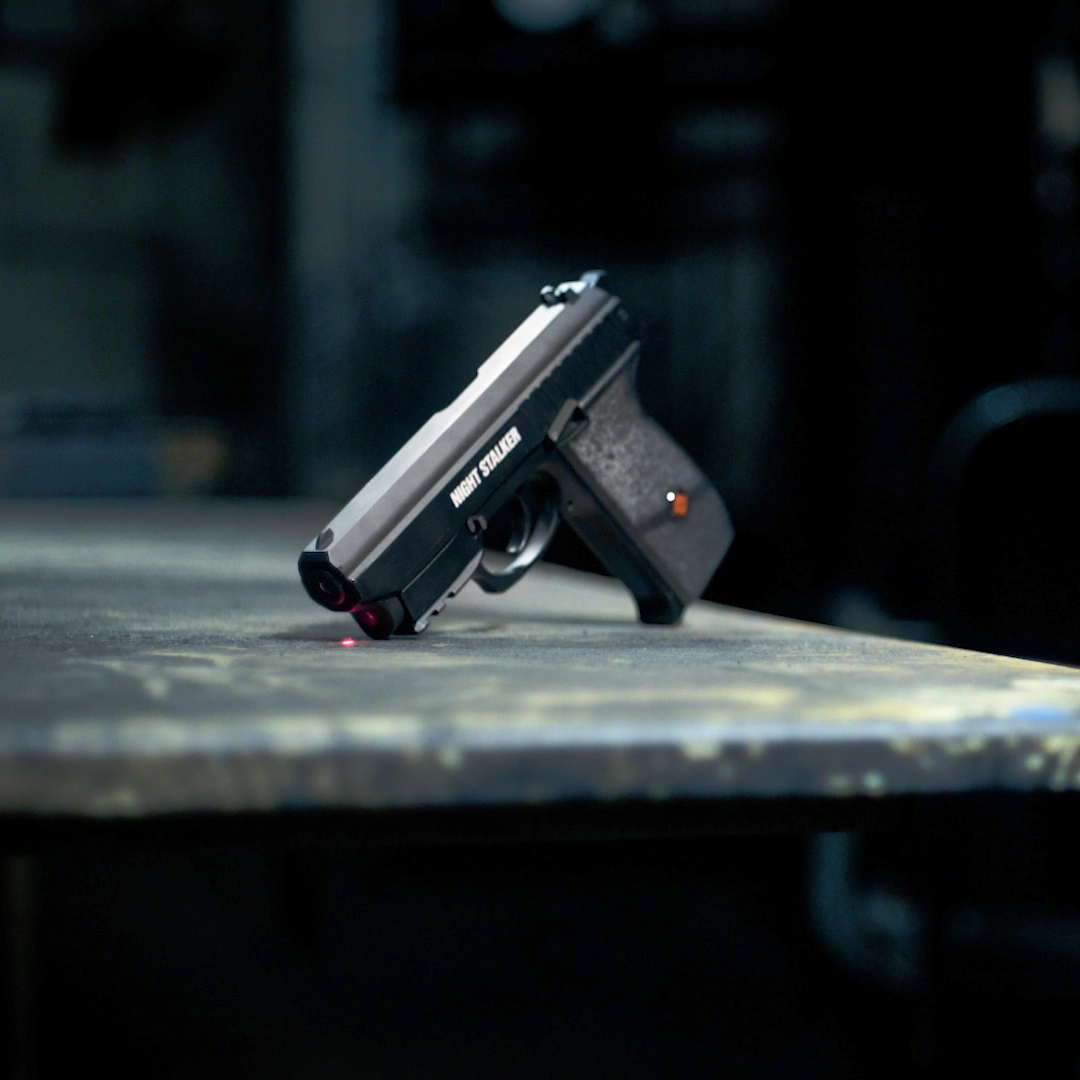 Crosman Night Stalker BB Pistol PFM520 Indoor Lifestyle Man Shooting in Dark Factory with Laser On