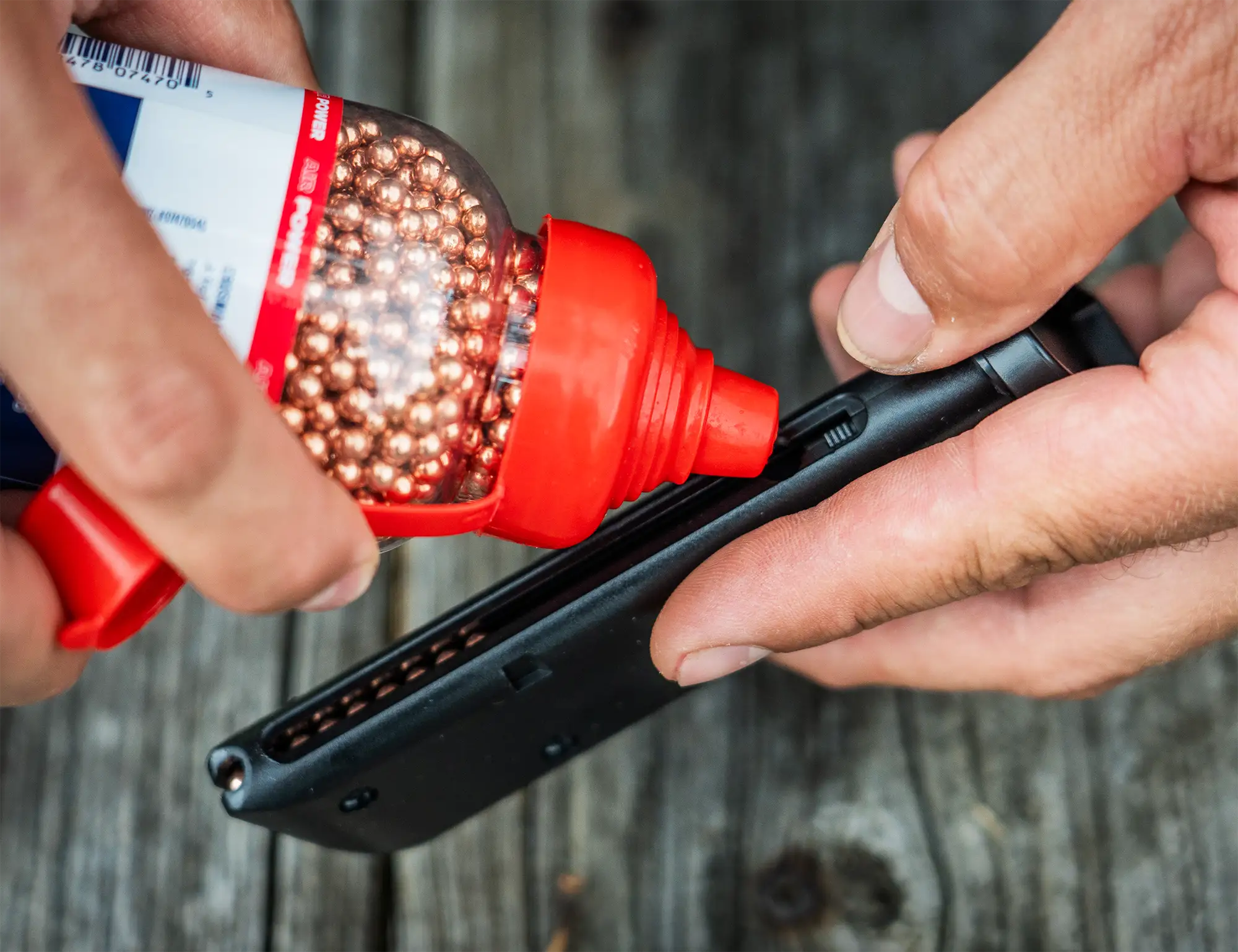 Crosman PSM45 BB Pistol Outdoor Lifestyle Being Loaded with BBs