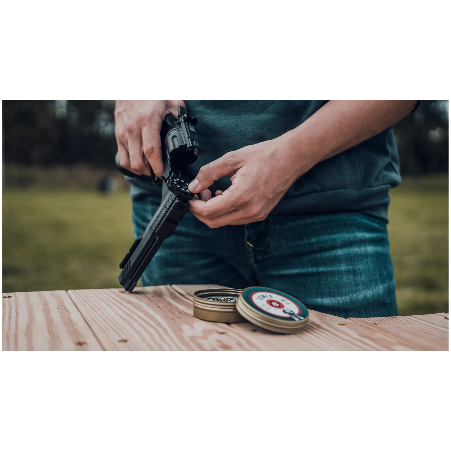 Crosman Vigilante CO2 Revolver Air Pistol with user loading pelelts to the pistol lifestyle picture