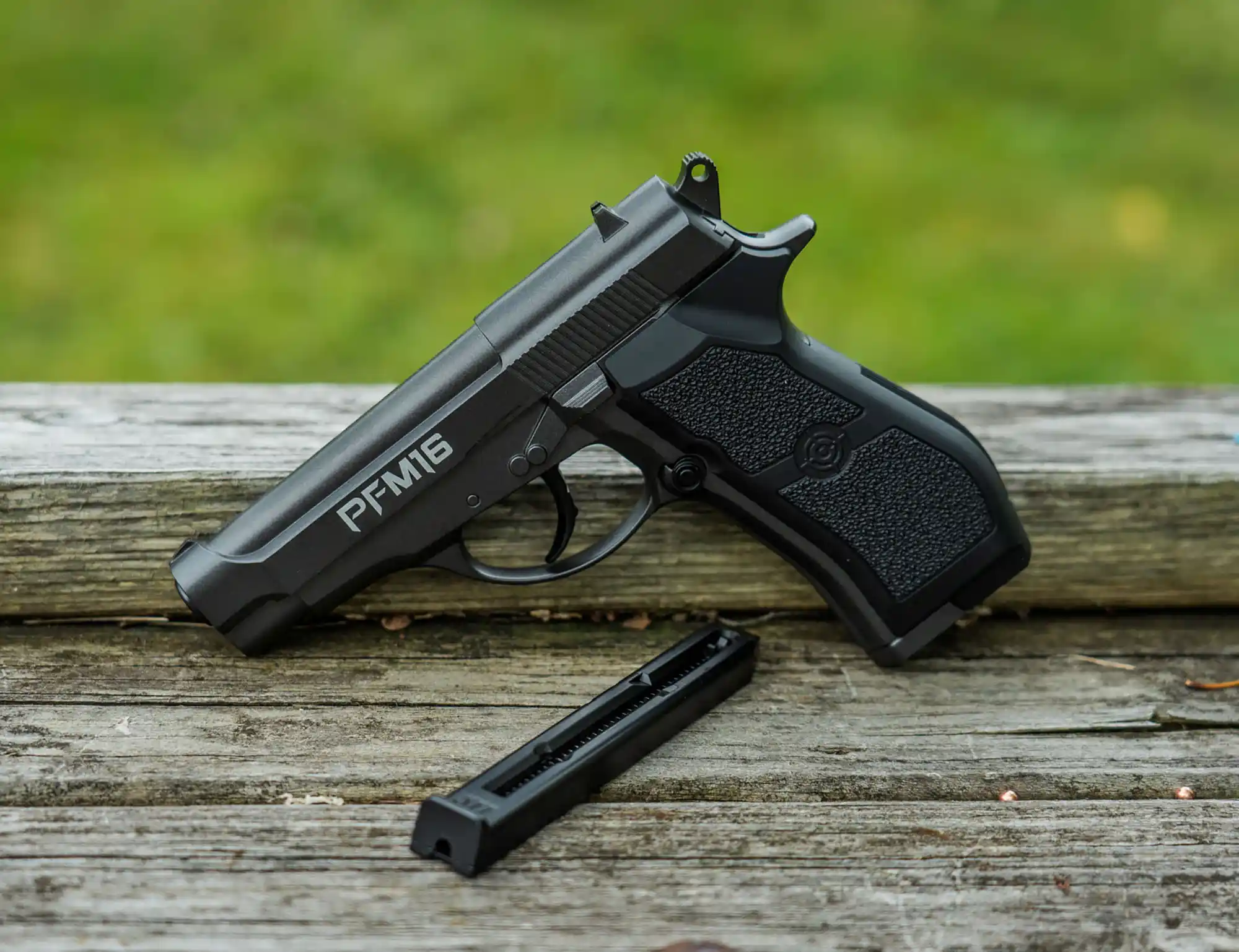 Crosman PFM16 (Black) C02 Pistol PFM16 Outdoor Lifestyle Sitting on a Bench
