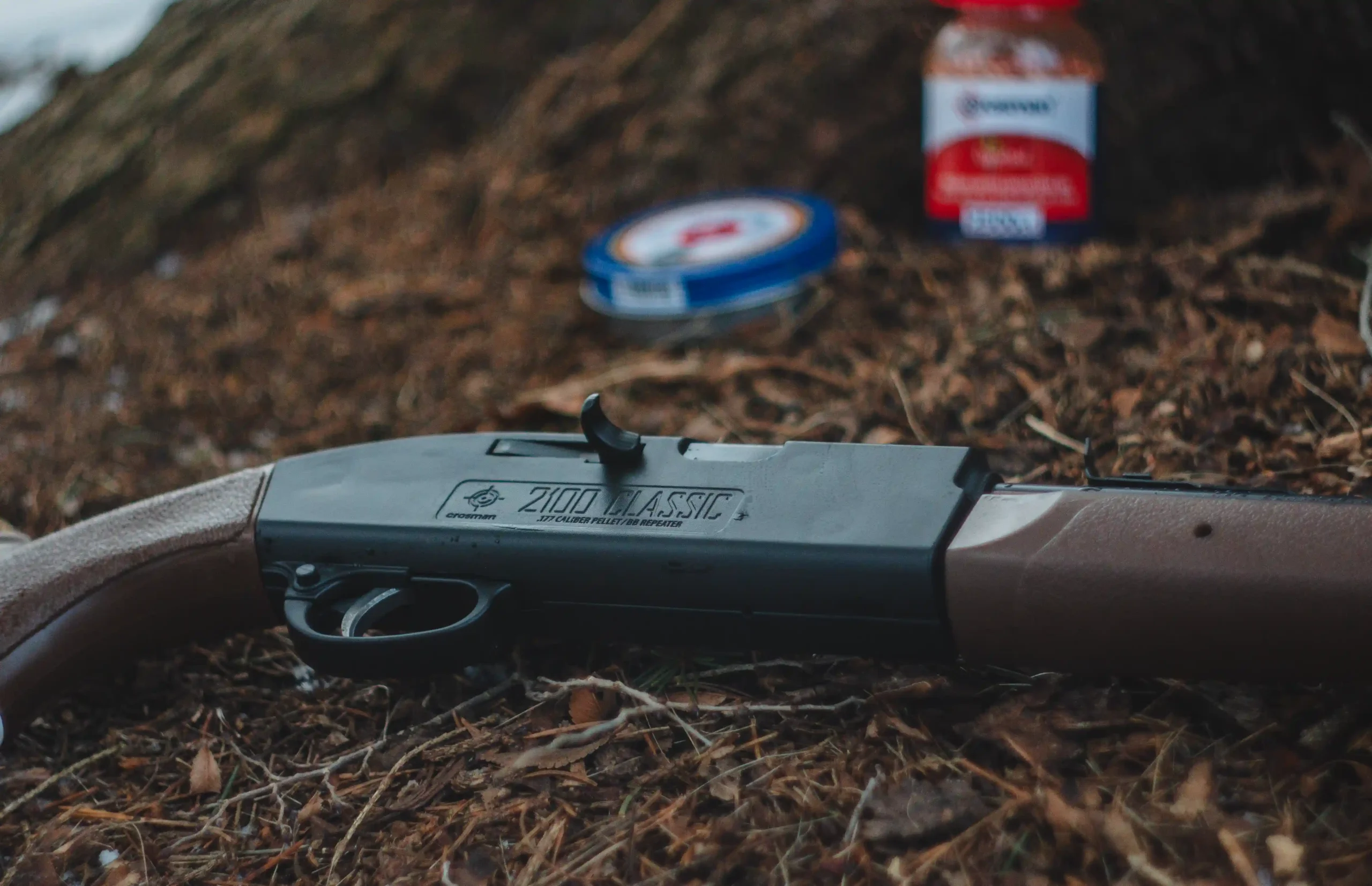 2100 Sitting on the ground with a Bottle of BBs and Can of Pellets in the Background