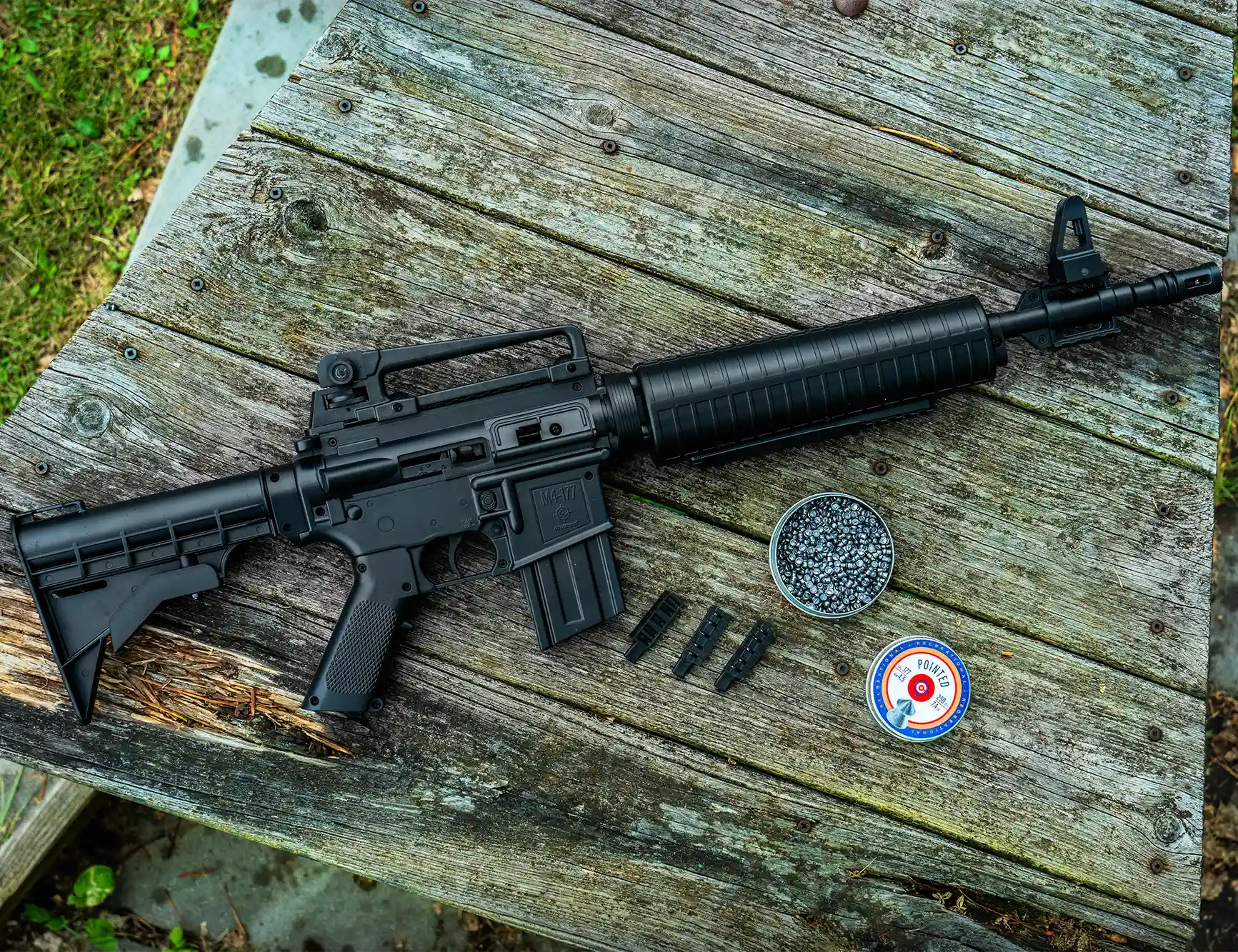 Crosman M4-177 .177 Pellet / BB Pneumatic Pump Air Rifle M4-177KT-N Outdoor Lifestyle Sitting on a Bench